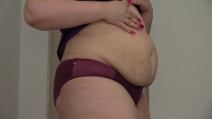 Fat woman with a big ass shakes stuffed belly. Fetish